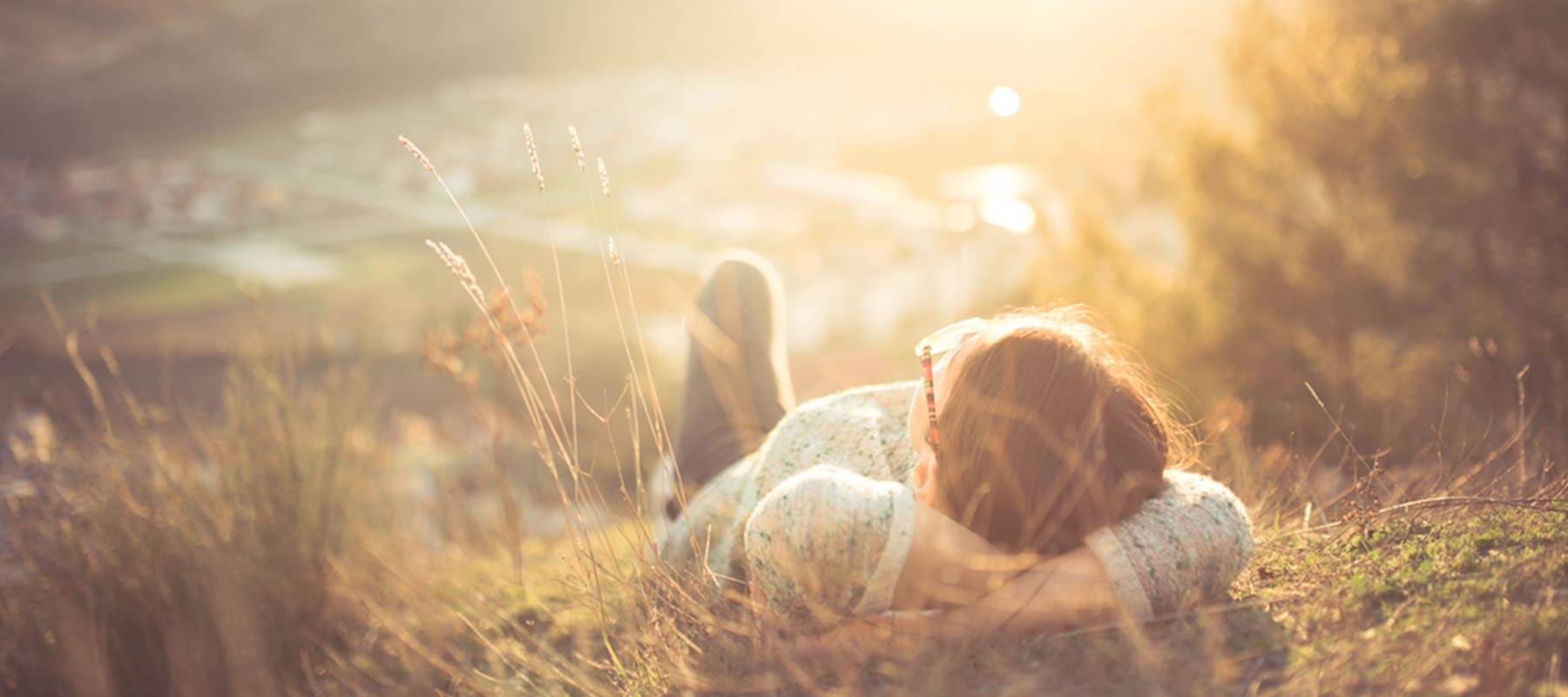 A woman relaxes on a hillside in France