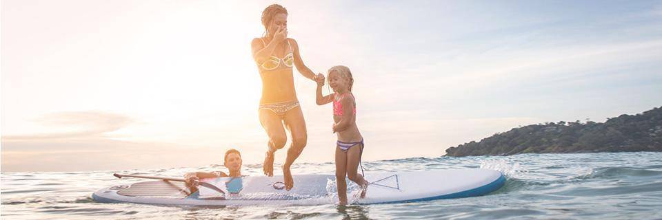  Une famille sautant d'un paddle board dans la mer